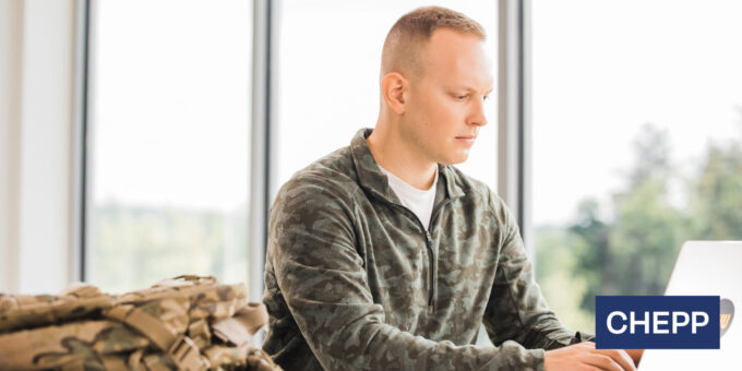 Student seated working on laptop computer