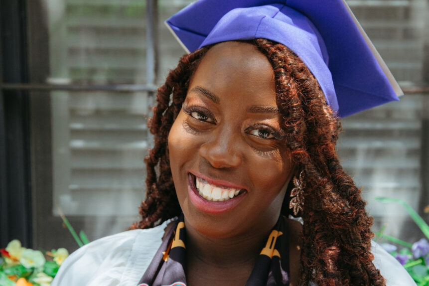 Woman smiling wearing regalia