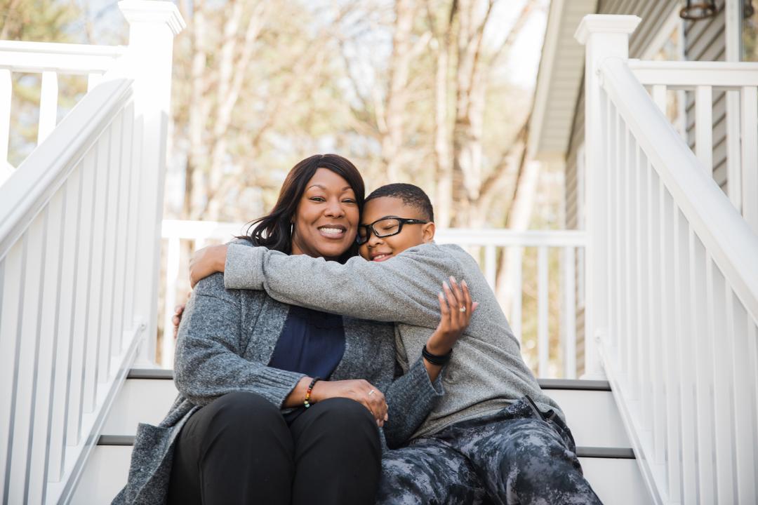 Parent and child on stairs of home