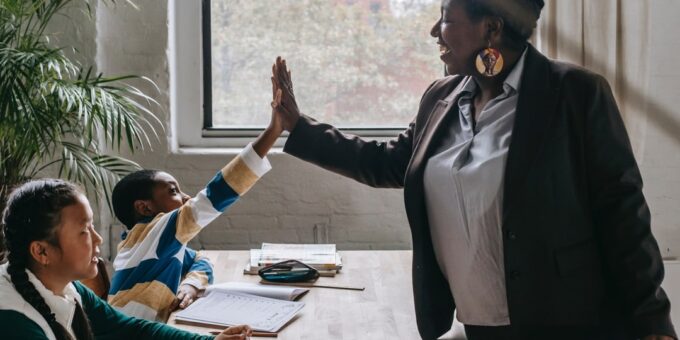 Teacher high-fiving student