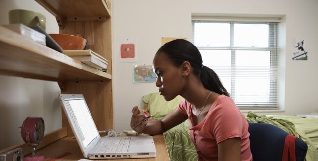 Student working on laptop at desk