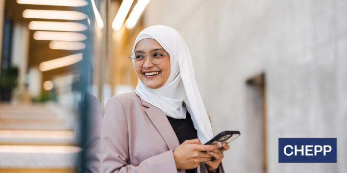 Woman smiling while using her cell phone