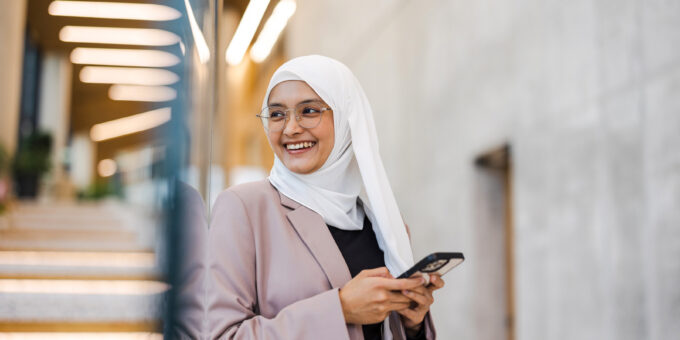 Woman smiling while using her cell phone