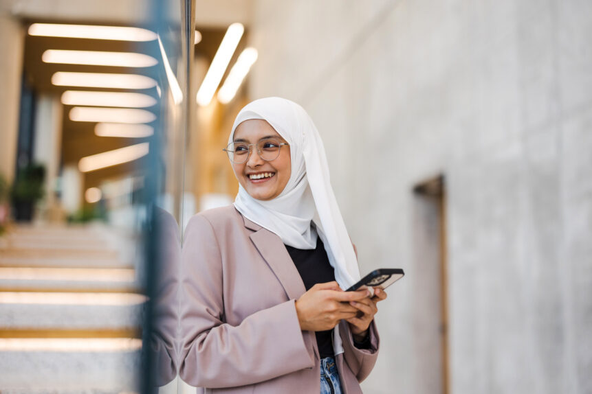 Woman smiling while using her cell phone
