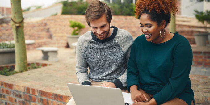 Two students working together on laptop