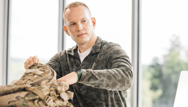 Person putting something in their backpack