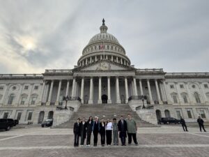 People standing in front of the capitol building.