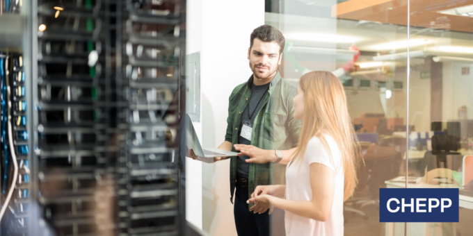 Two people collaborating in a modern office, reviewing information on a laptop beside server equipment, with the CHEPP logo displayed in the corner.
