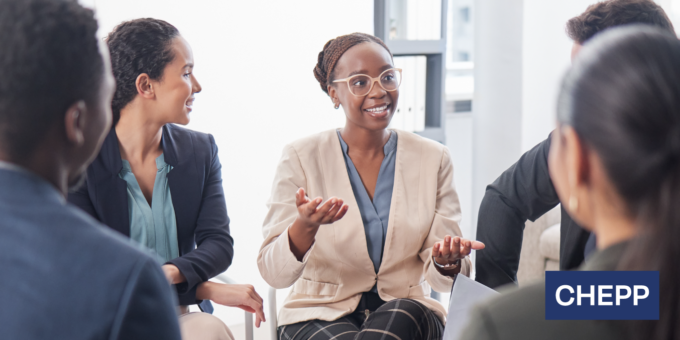 Group of people seated in a meeting, with one person speaking and gesturing during a collaborative discussion, and the CHEPP logo displayed in the corner.