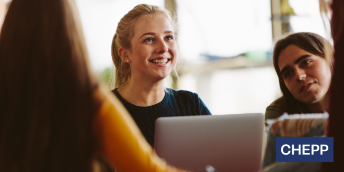 People gathered around a laptop in a collaborative discussion, with one person smiling as they engage with the group, and the CHEPP logo displayed in the corner.