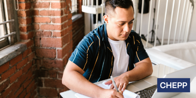 Person sitting at a desk writing in a notebook with the CHEPP logo in the bottom right corner.